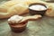 Homemade milk kefir grains on a wooden spoon above a clay bowl o