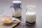 Homemade milk yogurt with fruit jam in porcelain bowl on table