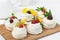 Homemade mini pavlova cakes with whipped cream and fresh berries