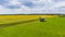 Homemade mobile trailer-hive with many hives placed on it near the sunflower field. Summer countryside landscape