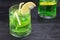 Homemade mojito in a glass on against dark background