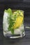 Homemade mojito in a glass on against dark background