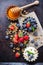 Homemade muesli granola and yogurt with berries on rusty table