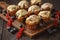 Homemade muffins with red currants and blueberry, covered with white chocolate topping.