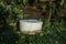 Homemade multi-colored candles with concrete on a background of green grass. handmade decor close-up. Details of a colored cube