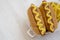 Homemade Mustard Hot Dog with French Fries on a white wooden table, high angle view. Copy space