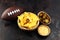 Homemade Nachos with Cheddar Cheese and Jalapenos for football. Great for Bowl Game party. Mexican tortilla chips with sauce