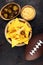 Homemade Nachos with Cheddar Cheese and Jalapenos for football. Great for Bowl Game party. Mexican tortilla chips with sauce