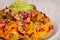 Homemade nachos with vegetable salad hash and guacamole. Closed image
