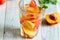 Homemade nectarine iced tea or lemonade with fresh mint and ice cubes in glass