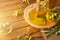 Homemade new harvest olive oil in container on wooden table