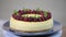 Homemade New York cheesecake on a cake stand decorated with fresh berries