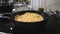 Homemade noodles placed inside pan on modern electric cooker