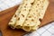Homemade Norwegian Potato Flatbread Lefse with Butter and Sugar on a rustic wooden board on cloth, low angle view. Close-up