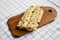 Homemade Norwegian Potato Flatbread Lefse with Butter and Sugar on a rustic wooden board on cloth, side view