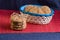 homemade oat cookies with sunflower seeds in and rear blue checkered basket on wooden table