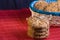 homemade oat cookies with sunflower seeds in and rear blue checkered basket on wooden table