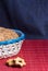 homemade oat cookies with sunflower seeds in and rear blue checkered basket on wooden table