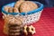 homemade oat cookies with sunflower seeds in and rear blue checkered basket on wooden table