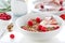 Homemade oat meal granola or muesli with fresh summer fruits â€“ raspberry and strawberry with yogurt