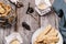 Homemade oatmeal cookies and candles in trendy organic candlesticks on grey vintage wooden table