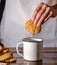 homemade oatmeal cookies in to a cup of milk, natural ingredients, pastry at home