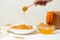 Homemade oatmeal porridge with seasonal autumn pumpkin in a white plate on a light background. autumn composition with wheat ears