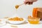 Homemade oatmeal porridge with seasonal autumn pumpkin in a white plate on a light background. autumn composition with wheat ears