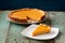 Homemade oldfashioned round pumpkin pie on old table painted blu