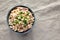 Homemade Olivier salad in a Bowl on a white wooden background, top view. Flat lay, overhead, from above. Space for text