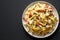 Homemade One Pot Chicken Fajita Pasta on a Plate on a black background, top view. Copy space