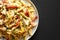 Homemade One Pot Chicken Fajita Pasta on a Plate on a black background, top view. Space for text
