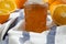 Homemade orange marmelade in glass jar, side view. Closeup