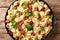 Homemade orecchiette with boiled broccoli and fried sausages close-up in a plate.. Horizontal top view