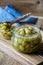 Homemade organic berry jam in glass jar on rustic wooden table