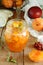 Homemade organic jam in glass jar and ripe apricots and nectarine on wooden rustic table