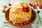 Homemade pancakes with honey, apple, cranberries and nuts