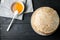 Homemade pancakes with honey and walnuts, vintage white plate, dipper, dark wooden table.