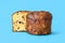 Homemade panettone isolated on a blue background. Sliced panettone