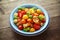 Homemade Panzanella, Tomato traditional Italian salad with red, yellow, orange cherry tomatoes, capers, basil and