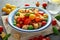 Homemade Panzanella, Tomato traditional Italian salad with red, yellow, orange cherry tomatoes, capers, basil and