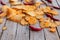 Homemade paprika potato chips on wooden table