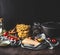 Homemade pasta on dark rustic kitchen counter with pot and fresh ingredients for tasty cooking: tomatoes, olives oil, parmesan,