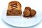 Homemade pastries sprinkled with cocoa. Butter roll with chocolate balls on a large plate. Handmade chocolate roll, isolate on