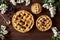 Homemade pastry apple pie bakery products on dark wooden kitchen table with raisins, honey and apples. Traditional