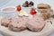 Homemade pate, olives, tomatoes and slices of bread on wooden board