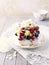 Homemade Pavlova with Fresh Fruits and Coconut; Cake with blueberries, strawberries, grapes, raspberries and coconut