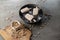 Homemade peanut ice cream or popsicles garnishes with peanut grains and pieces of ice on a rustic gray table, top view