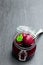 Homemade pickled baby beetroot in glass preserving jar on black stone background