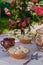 Homemade pierogi in clay ethnic Ukrainian dishes on a table in the summer garden